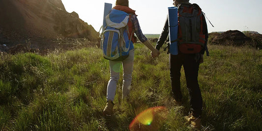 Young couple hiking with backpack.