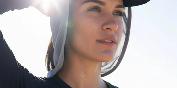 Athlete using neck cooling gear to reduce heat and UV stress during outdoor training.