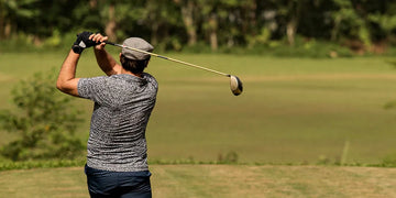 A man golfing in a sunny day