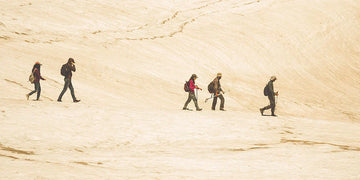 Hikers on top of a desert hill