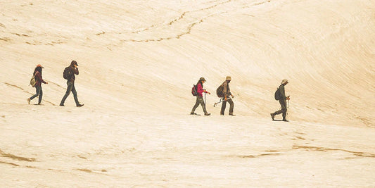 Hikers on top of a desert hill
