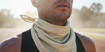 Athlete using UPF neck and face protection during long sun exposure.