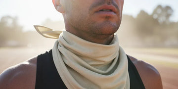 Athlete using UPF neck and face protection during long sun exposure.