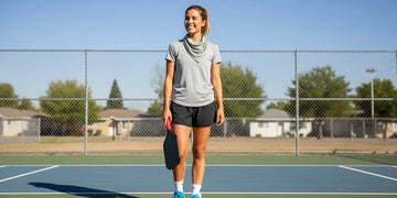 Beginner pickleball player on an outdoor court with basic gear.