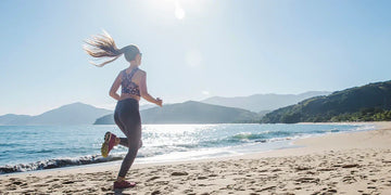 woman running fast on the sand in a sunny day