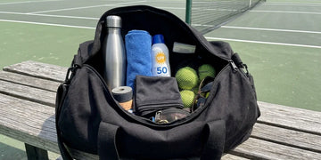 Organized summer sports bag with hydration, cooling gear, and accessories.